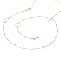 Close-up of golden glasses chain with metal ring accents and silicone connectors - Round