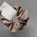 Detail of silk champagne hair scrunchie with rhinestones and nyu nyu Korean tag - Khaki
