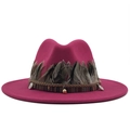 Close-up of rose red fedora with feather trim, woven bands and metallic charms - Rose Red