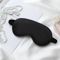 Luxurious black silk sleep mask with elastic strap shown with elegant pearls and perfume - Black Plastic Eye Mask