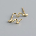 Close-up of gold snake earrings featuring sparkling zirconia studs on a grey surface - 925 Silver / Gold