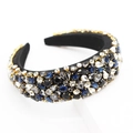 Close-up of baroque wide headband with blue and black rhinestones in gold metal claws - Blue