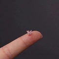 Rose gold butterfly stud earring with pink zircon stones displayed on a fingertip - Pink Butterfly Style (4#R)