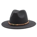 Detailed close-up of brown braided cord and vintage gold skull emblem on a black wool hat - M (55-58cm) / Black