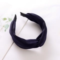 Detail of dark blue twisted fabric headband with velvet texture on a clean surface - Royal Blue
