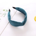 Close-up of a wide dark green satin headband featuring a chic twisted knot detail - Peacock Green