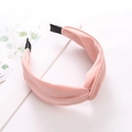 Detail of pink wide knot headband with silky fabric texture on a minimalist background - Korean Pink