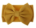 Detailed close-up of yellow oversized bow headband in soft textured knit fabric - Turmeric