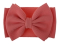 Macro shot of coral pink waffle fabric texture on a large baby bow headband - Dusky Pink