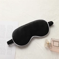 Black satin sleep eye mask with white piping detail and elastic strap on linen background - Black with White Edge