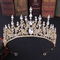 Detailed close-up of Baroque gold bridal crown with crystals on vintage books - KC Gold White Rhinestone