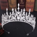 Macro shot of silver bridal tiara with rhinestones over vintage books background - Thick Silver White Rhinestone