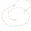 Detail of golden glasses chain with geometric square beads and silicone anti-slip loops - Square