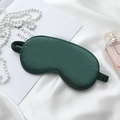 Deep green faux silk sleep mask with elastic strap on elegant white satin backdrop - Trendy Green Eye Mask