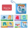 Detail of baby soft cloth book showing colorful wearing themed pages and hanging loop - Wearing