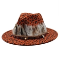 Detailed close-up of orange leopard print fedora with ethnic beads and feather trim - Orange Red