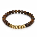 Minimalist tiger eye bead bracelet featuring golden polished metal accents - Gold