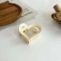 Dettaglio di un elegante fermaglio per capelli color crema a cuore su vassoio in legno - Cuore / Beige