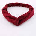 Burgundy knitted twist headband with ribbed texture and elastic band on white background - Burgundy