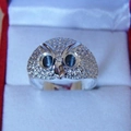 Macro shot of silver owl ring featuring detailed feather texture and black gemstone eyes - US 7 / Silver