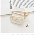 Detail of 5-piece golden pearl hair clip set on display card with magazine background - Style 8# (5-Piece Geometric Wave Metal Set)