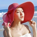 Detalle de sombrero de paja rojo de ala ancha con lazo para protección solar de playa - Rojo Sandía