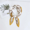 Pleated silk scarf featuring ginger yellow and ivory chain patterns tied in a loop - Anchor Chain Yellow Border