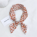 Orange cotton linen skinny scarf with white floral pattern tied in a soft knot - Rangoon Creeper Orange
