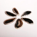 Detailed view of seven natural agate slices with unique patterns and top-drilled holes - Black