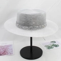 Detail of white boater straw hat featuring a silver sequin band on a minimalist stand - M (56-58cm) / White