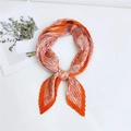 Orange pleated scarf with paisley print and pointed ends on a minimalist white surface - Paisley Wave Orange