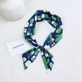 Navy blue cotton linen scarf with cactus print tied in a bow on a white surface - Cactus Navy Blue