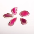 Detailed view of five pink agate slices with natural textures and pre-drilled holes - Rose Red