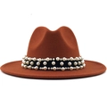 Detail of caramel fedora hat featuring a black ribbon band with rows of elegant white pearls - Caramel color