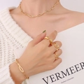 French style gold jewelry set with geometric necklace bracelet and rings on a model - Gold Octagonal Hollow Chain Necklace & Ring Set-P1155
