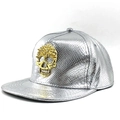 Detail einer silbernen Snapback Cap mit Schlangenmuster und goldenem Totenkopf-Nietendekor - Verstellbar / Silber
