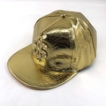Close-up of golden flat brim hip-hop hat with crocodile texture and rhinestone dollar sign - Adjustable / Gold