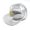 Detail view of silver snake-patterned leather cap with a golden rhinestone dollar sign logo - Adjustable / Silver