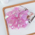 Macro detail of iridescent organza scrunchie with shimmer texture and ruffles - Purple