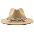 Close-up of khaki wool fedora with woven band, tassels, and natural seashell detail - Camel