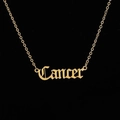 Macro detail of gold stainless steel necklace with Gothic Cancer zodiac pendant - Cancer / Gold