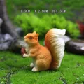 Miniature resin squirrel figurine holding a pinecone, size 5x2.8x4.5cm for fairy gardens - Squirrel Holding Nut