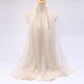 Close-up of lightweight breathable cream chiffon fabric texture on a long sun shawl - Beige