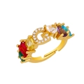 Macro shot of gold G-letter ring with rainbow gemstones and micro-pave crystals - Adjustable Open / Letter G