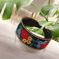 Detail of embroidered floral headband with colorful patterns on black wide band - Standard Type / Red Flower