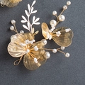 Detail view of handmade gold floral hairpiece with woven metal petals and white pearls - Style 3 Side Decoration