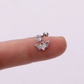 Macro shot of a silver heart wing stud earring with crystal stone held on a fingertip - Wing Heart (Silver 3#) / Silver