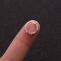 Macro shot of silver circular nose ring with colorful micro-set cubic zirconia on finger - 2# 8mm Top-Mounted Zirconia