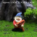 Miniature garden gnome statue with blue hat holding a welcome sign, 4.8cm height - Gnome with Welcome Sign