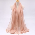 Detailed view of light pink voile scarf with delicate overlock edges on a mannequin - Nude
